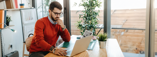A man in the office wearing a 2-in-1 sweater